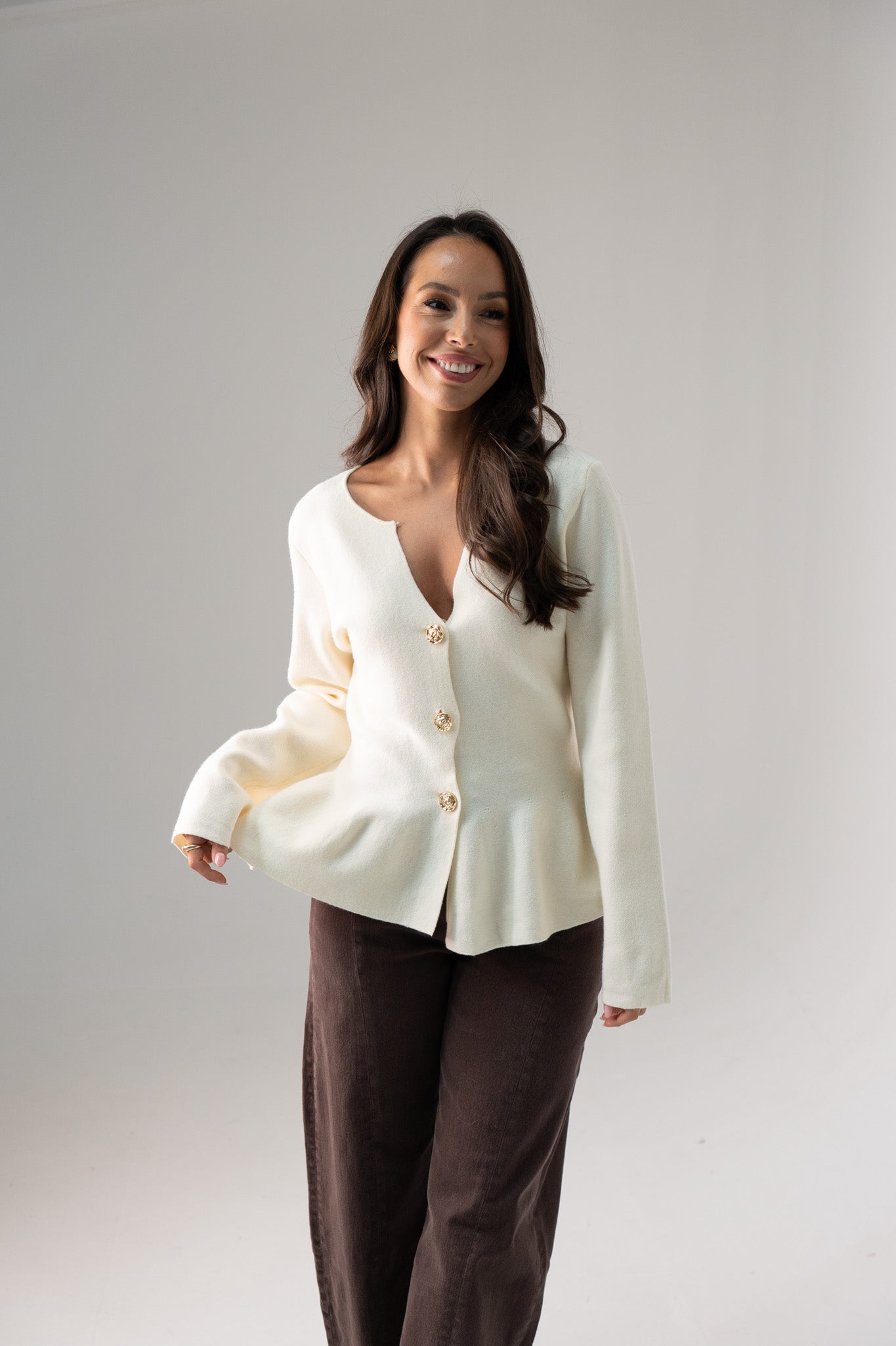 Ally Peplum Cardigan In Cream